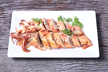 Grilled Stuffed Squid with garlic and pork. Thai style isolate on white plate