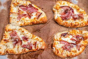 Freshly baked homemade peinirli with cheese and ham symbolizing comfort food and Mediterranean tradition.