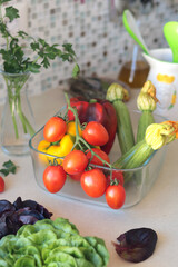 Fresh vegetables in glass bowl in kitchen. Mosaic tiles on wall in Italy. Eco-friendly farm products and healthy eating, longevity. Mediterranean cuisine.