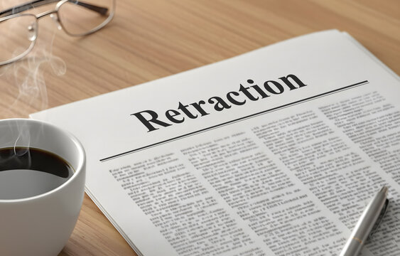 A newspaper with the headline Retraction