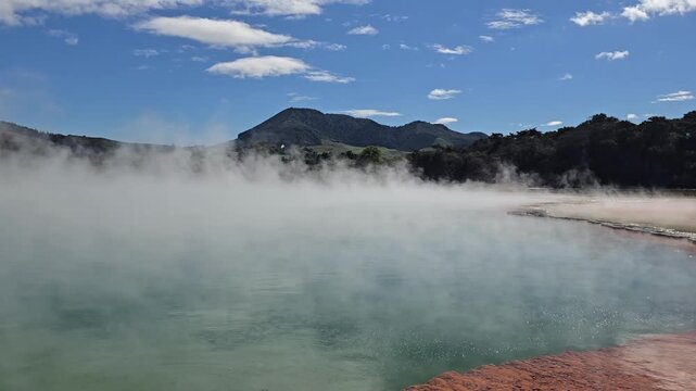 The Mist Rises over the Mountain behind from the Hot Springs of New Zealand
