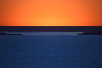 water surface and horizon in evening light, evening seascape, unusual colors.