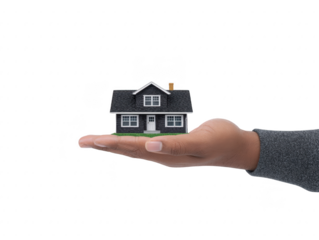 Hand holding small black house model with white windows and door, symbolizing real estate, home ownership, and security in concept image
