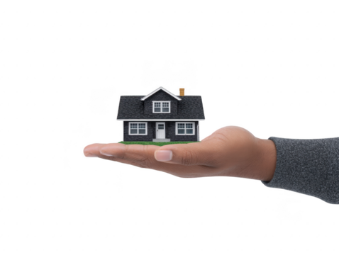 Hand holding small black house model with white windows and door, symbolizing real estate, home ownership, and security in concept image