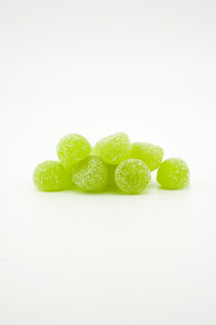 Cannabis thc, cbn, cbd jelly green Gummies, medical drug products. Marijuana infused gummy candies food products portrait format photo on a white background