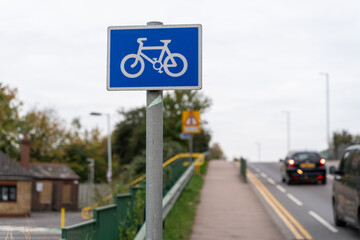 Bicycle path sign near busy road