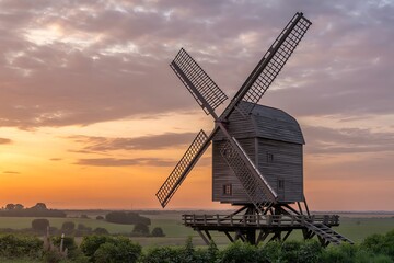 Stunning windmill silhouetted against vibrant sunset sky evoking peace and nostalgia perfect for travel blogs and historical projects