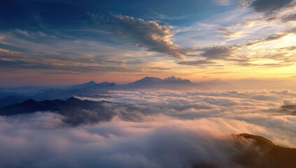 Fototapeta premium Sunrise over mountain range shrouded in clouds