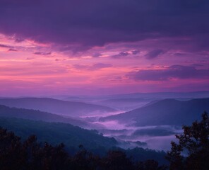 Naklejka premium Misty mountain valley at vibrant sunrise