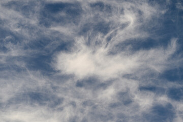 Fluffy, White Clouds Floating Gracefully Against a Clear, Vibrant Blue Sky Above Us