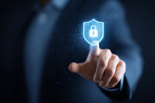 Touching a Digital Security Shield Symbol on a Screen in a Dark Environment During a Business Presentation