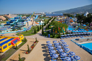 Gelendzhik resort. Zolotaya Bukhta water park. A large amusement park with a lot of rides and a lot of umbrellas.