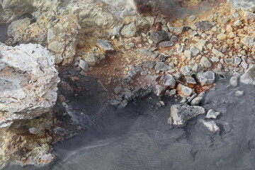 colorful sediment of sulphuric crystals on rocky volcanic soil in the geothermal area of Seltun, Iceland