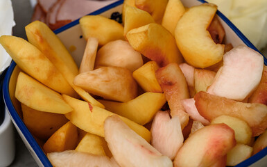 Peaches and nectarines cut into eighths, close-up of the fruit in the bowl