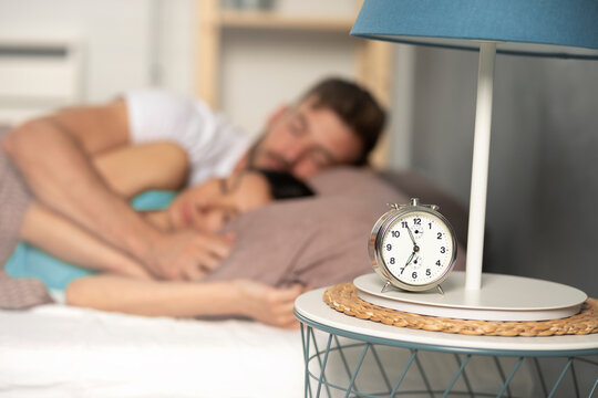 A young couple sleeps peacefully in each other's arms