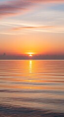 Obraz premium Serene Sunset Over Calm Ocean Waters Reflecting Golden Light.