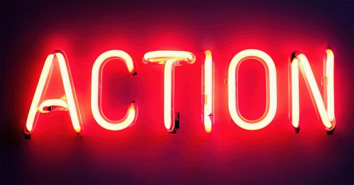 Bright red neon sign spells ACTION. Bold lettering dominates dark background. Simple, direct message radiates energy, impact.