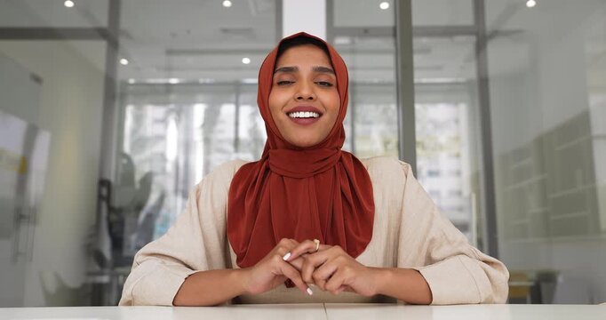Positive Indian business woman in hijab waving hello at camera,