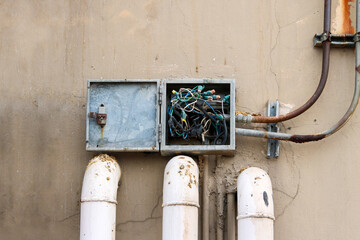Electric box is very old, tangled wire and around the box is dirty from bird droppings