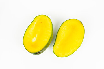 Ripe yellow mango halves lie side by side isolated on a clean white background for fruit display.