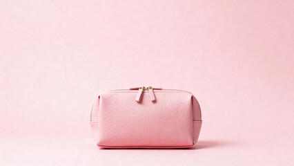 Pink cosmetic bag with zipper closure on a soft pink background