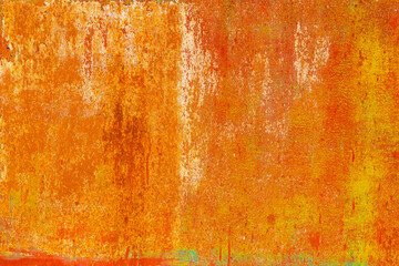 Close-up of a weathered rusty metal surface with a vibrant orange and yellow texture. The corroded...