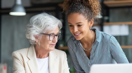 Two women share a warm moment while discussing ideas in a bright inviting workspace.