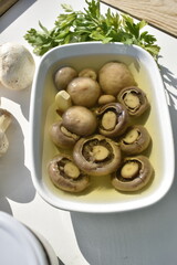 Marinated Mushrooms in a Bowl on White Background Top View
