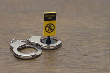 A powerful warning sign with a handcuff symbol, starkly illustrating the legal ramifications and...