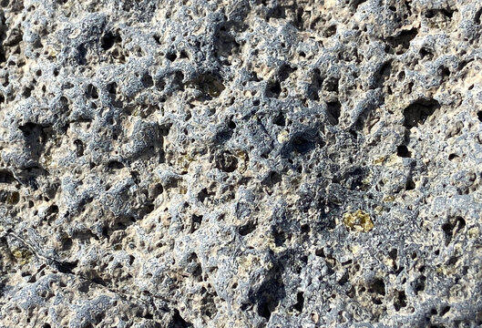 Olivine gemstones included in black lava basalt rock in Tenerife,Canary Islands,Spain.Peridot crystals. Selective focus.
