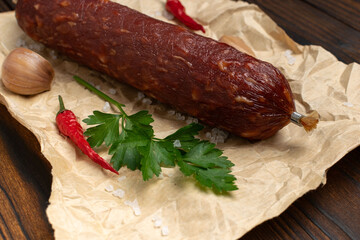 Smoked Sausage with Parsley, Garlic, and Red Chili Peppers on Rustic Wooden Table