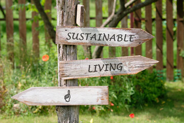 Wooden signs point towards sustainable living options in a serene garden full of greenery and blooming flowers, promoting eco-friendly lifestyle choices in harmony with nature