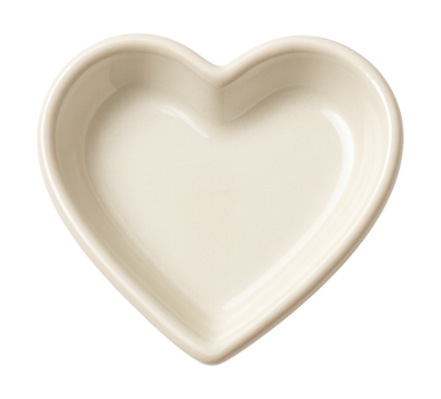 A petite ceramic heart dish for holding jewelry on a dresser in the master bedroom.