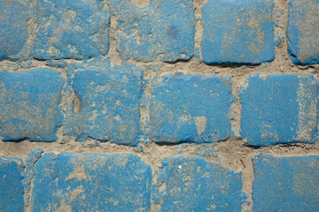Old granite cube painted blue. Cobblestone, street, texture, paint, surface, rough. Design space. Top view.