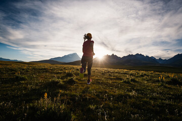 Runner running on the high altitude grassland mountain top