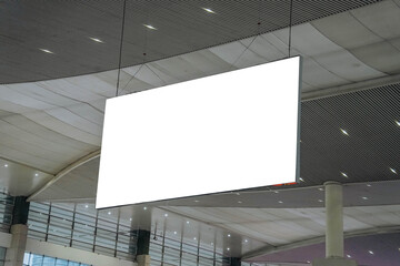 Blank advertising billboard hanging in the train station. Blank White Banners Hanging From Ceiling. Hangers Mockup Ready For Branding Or Advertising
