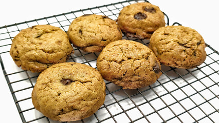 front view of golden brown sweet classic cookies on wire rack on white background