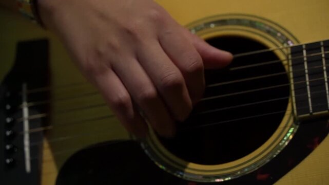 Slow motion of woman playing guitar solo on electric guitar closeup. 4k video footage concept music school, online lessons, bar