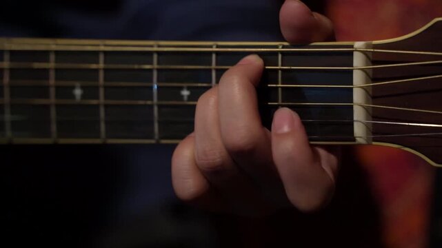Slow motion of woman playing guitar solo on electric guitar closeup. 4k video footage concept music school, online lessons, bar