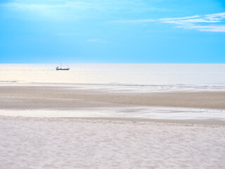 Small Fishing Boat on Bright Blue Sea at Sunrise