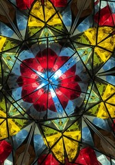 A vibrant kaleidoscope pattern featuring red yellow and blue geometric shapes and black lines design