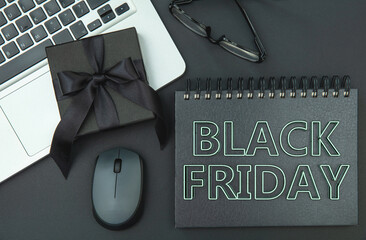 Black Friday sale, gift box and a laptop on an office table, online shopping sales