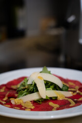 Beef carpaccio with arugula and parmesan cheese