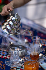 Pouring Hot Tea into Traditional Glass