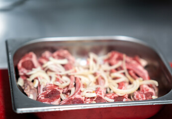 Raw Meat with Onions in Metal Tray