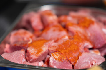 Raw pork pieces with paprika spice