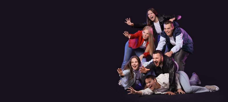 Group of angry young people reaching for something on dark background with space for text. Cyber Monday - Powered by Adobe