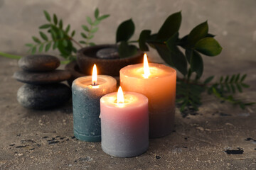 Spa composition with candles on dark background, closeup