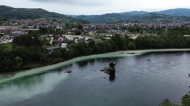 Famous Drina River house on a rock near Bajina Basta, Serbia, surrounded by water and forested mountains. Unique landmark and popular tourist attraction. Vertical aerial 4k footage