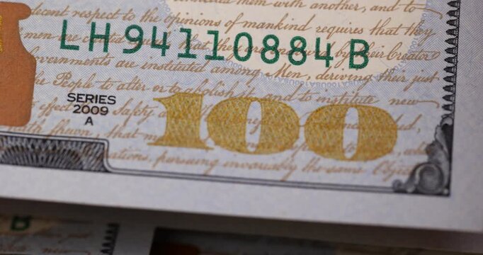 figure one hundred of the face value of genuine American dollars in close-up, details of a group of American dollar banknotes